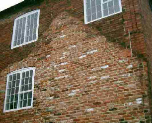 Side view of a house with marks where previous building stood