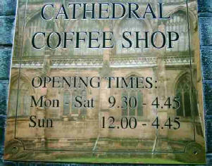 Cathedral coffee shop sign in brass with cathedral reflected in it