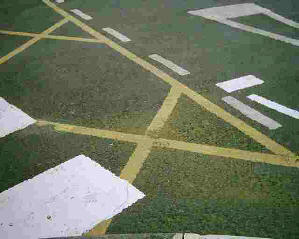Many signs painted on the road surface at a crossing