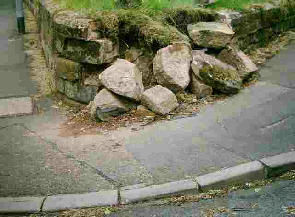 Damage to a wall on a street corner