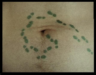 A man's navel with tiny footprints leading into his belly button