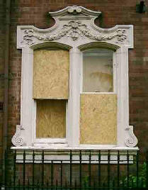 Old window half boarded up