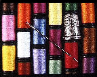 Coloured cotton reels with a needle